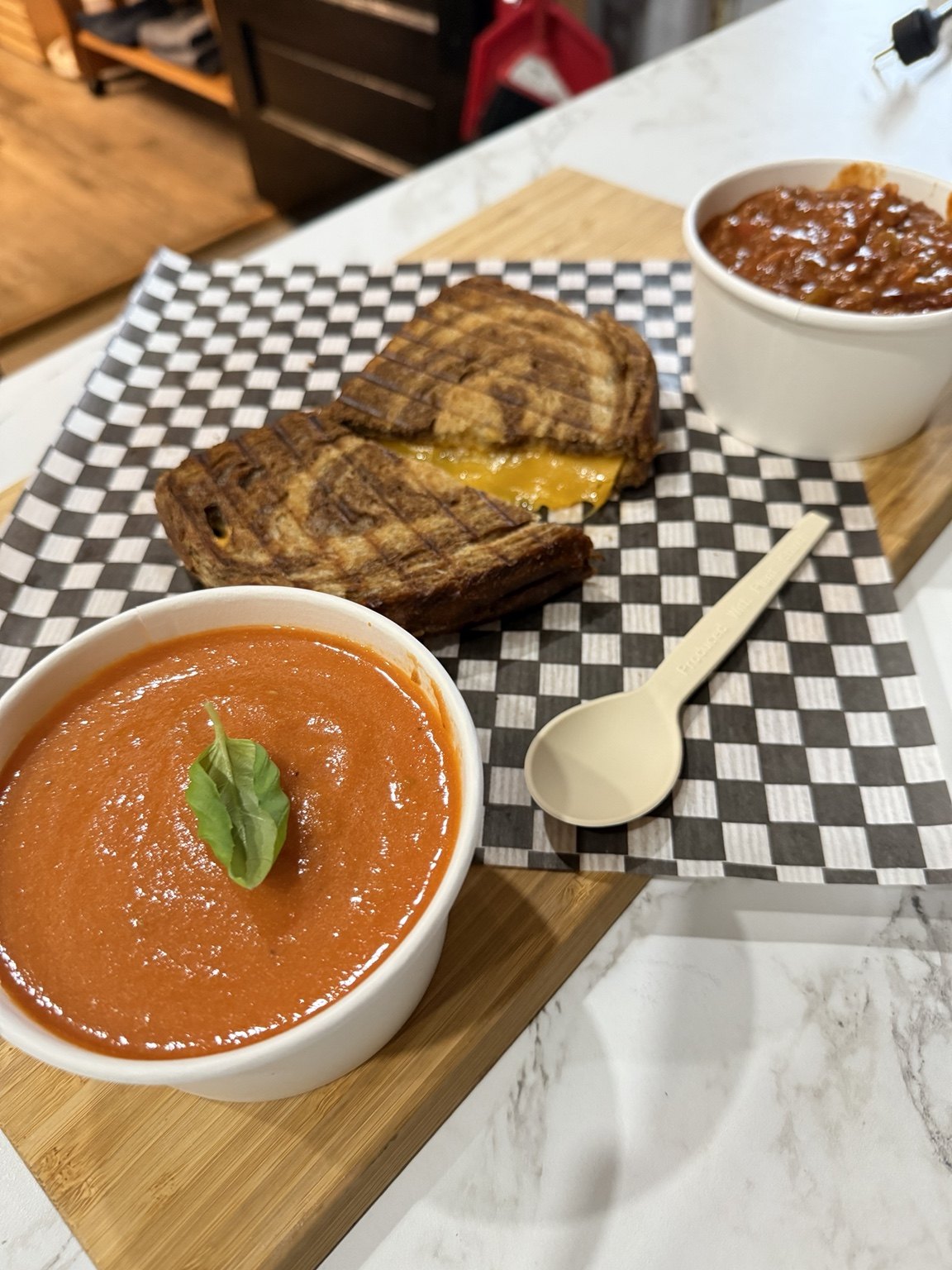 Soup and a grilled sandwich served together