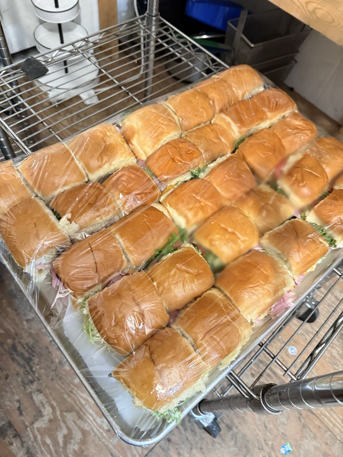 A tray of filled sandwich rolls prepared for catering