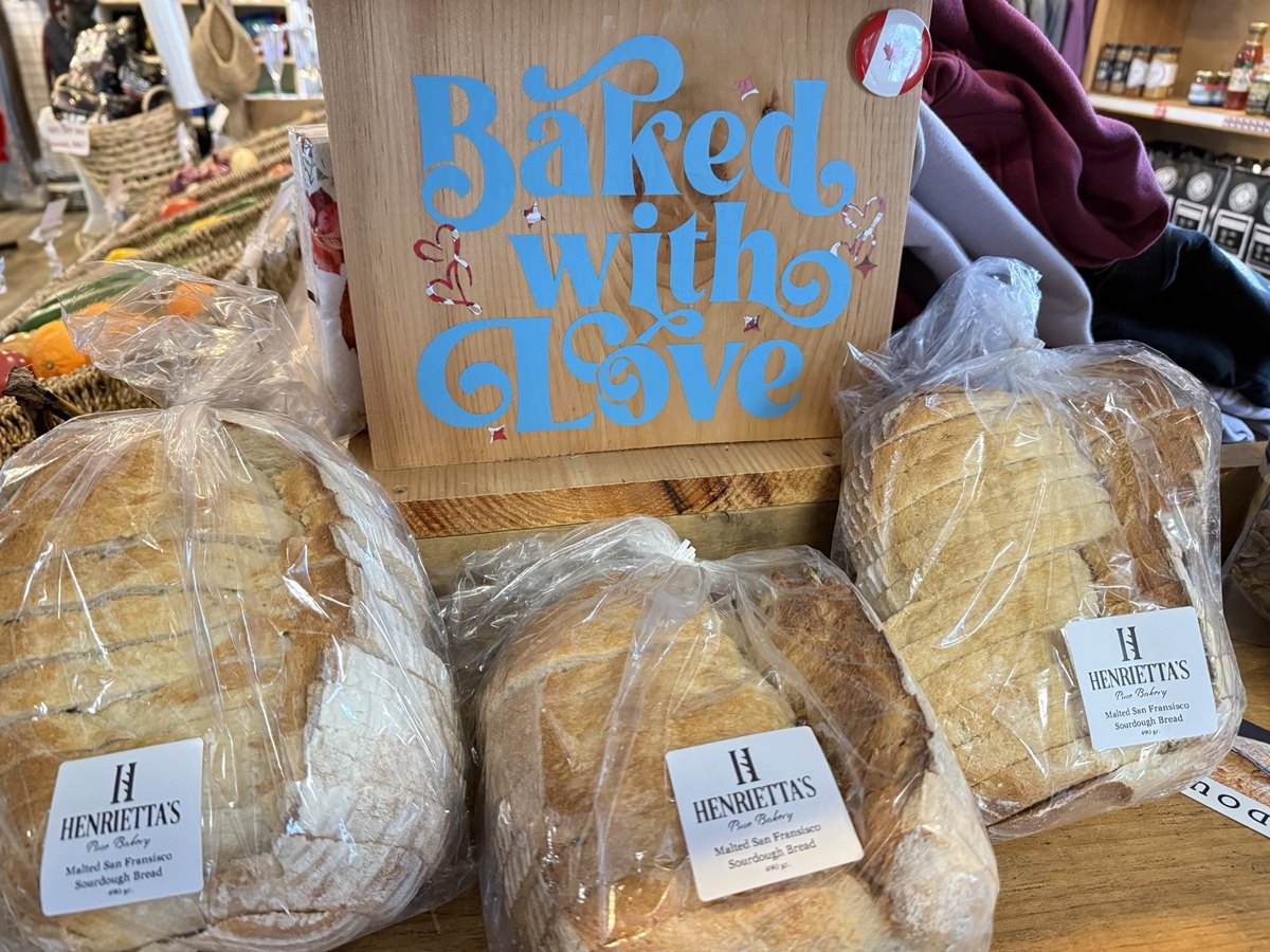 Henrietta’s packaged baked goods in the store, beside a Baked with Love sign