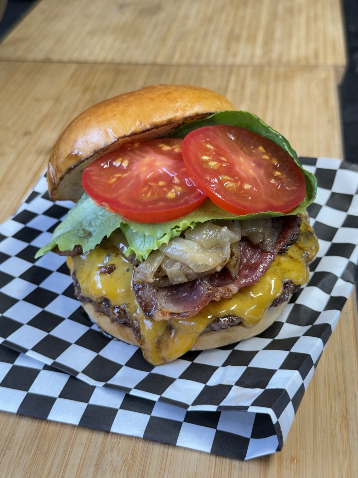 A Bear’s Den burger topped with cheese, lettuce and tomato