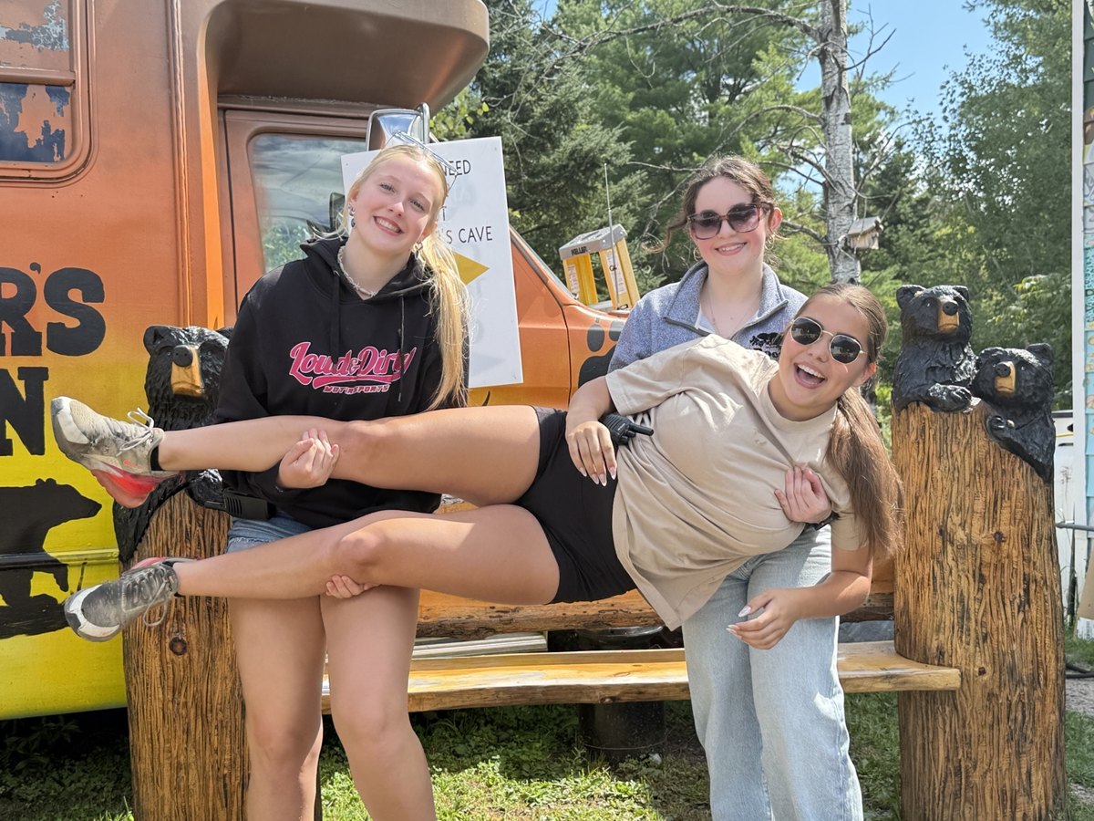 Bear’s Den team members sharing a lighthearted moment outside the chip truck