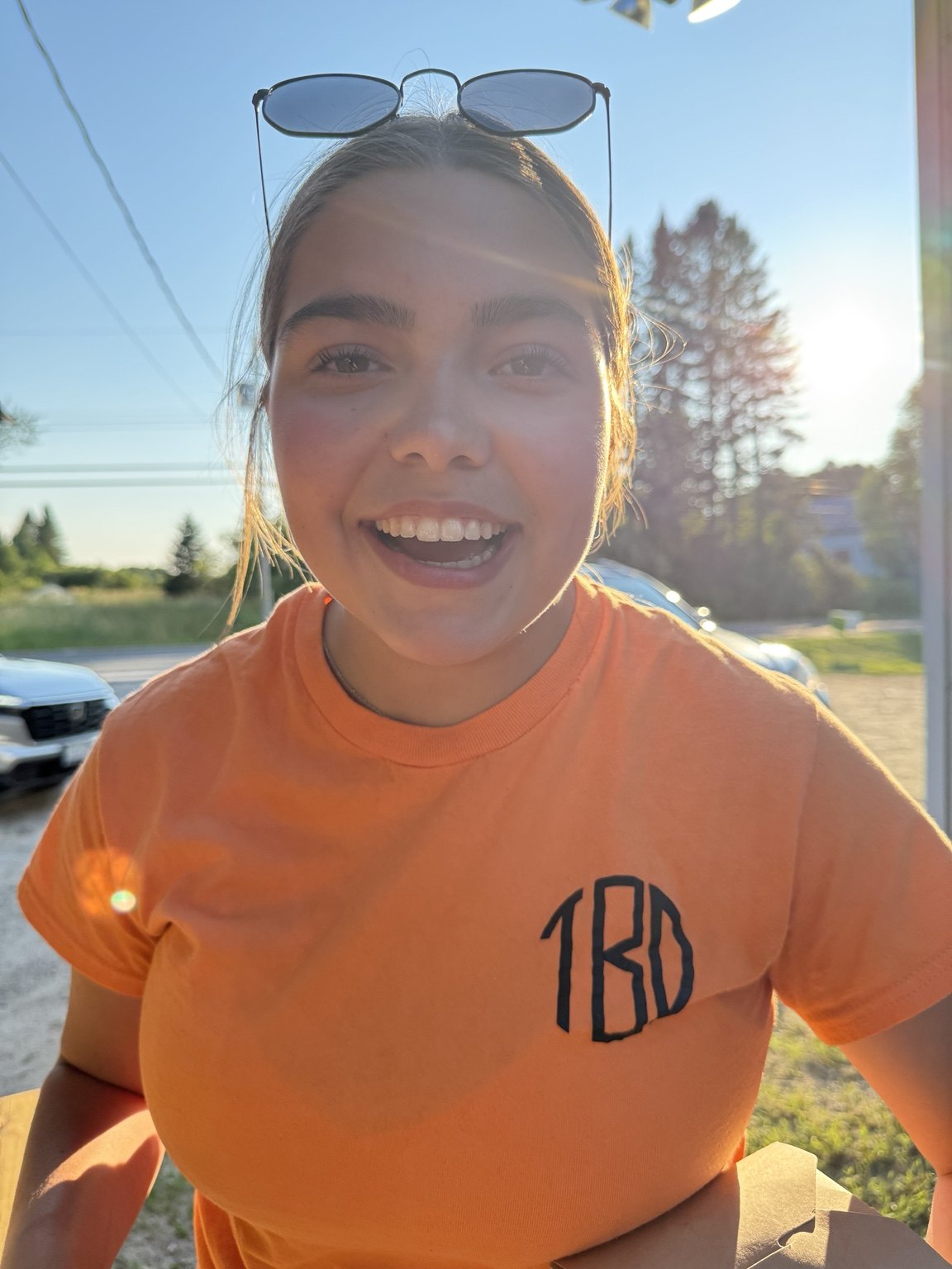 A smiling Bear’s Den team member in an orange team shirt